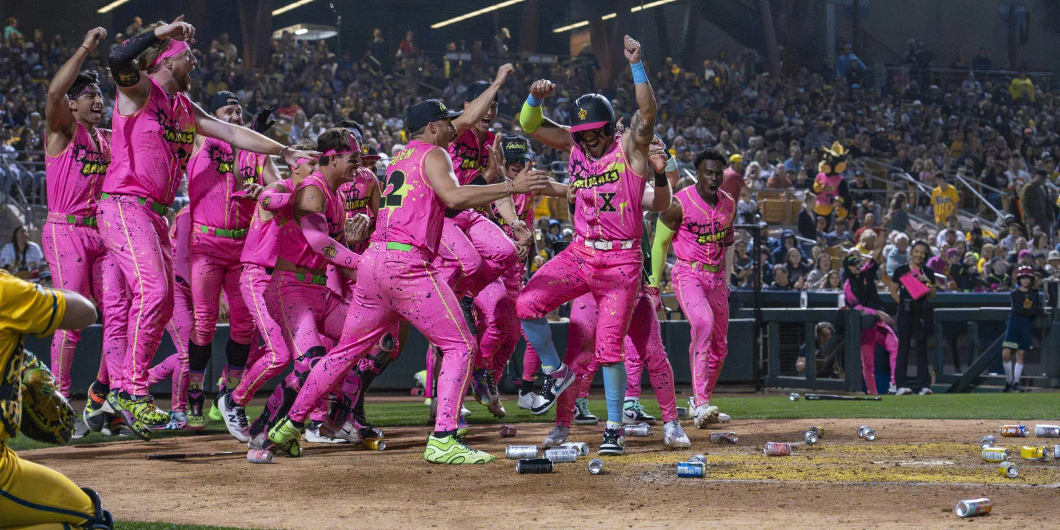 Party Animals players celebrate in pink uniforms during Banana Ball