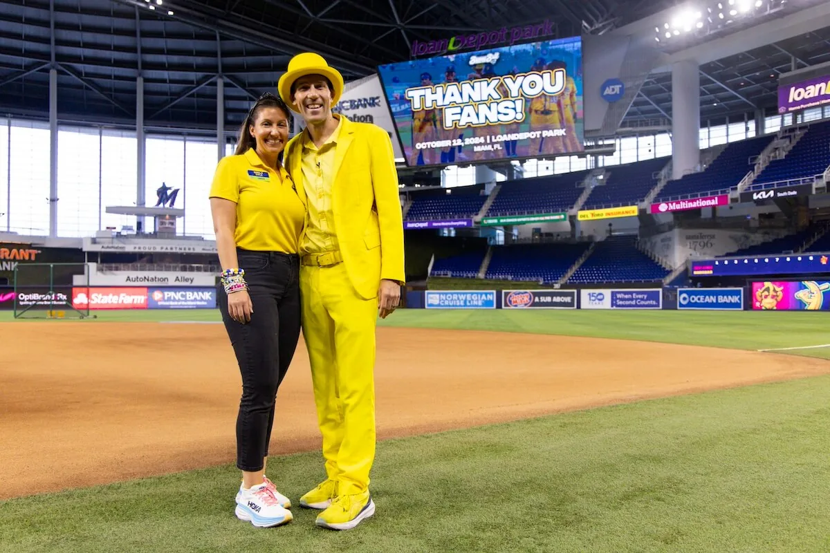 Savannah Bananas co-owners Emily Cole and Jesse Cole together on the field at loanDepot park